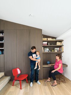 Odd Angles Don't Stop This Apartment's Transformation - Photo 1 of 8 - Iason Vassiliou, Maria Voutsina, and their daughter, Angeliki, relax in a landing-level office at their apartment in Athens, Greece.