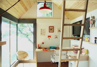 Reclaimed materials like salvaged windows and doors kept costs down, while white paint, bright customized workspaces, and custom millwork keeps things airy on the interiors.