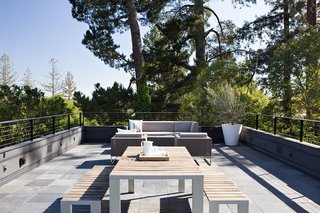 The roof deck is a place for entertaining, and offers scenic hillside views. During the design process, the team was challenged with preserving these views while adhering to the required 3.5-foot railing height mandated by building code, a height that would block all views while seated. As a solution, the team came up with open metal railings that would maintain safety while preserving the view.