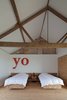 Modern home with Bedroom and Bed. A guest room in this repurposed barn in the English countryside lets the ceiling do the talking. Photo by Christoffer Rudquist. Photo of Examples of Rustic Modern Done Right