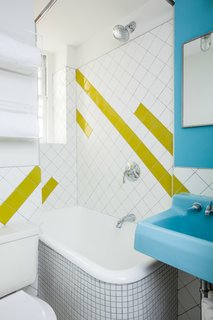 A geographic lime-green tile pattern was incorporated into the bathroom to complement the sink, which was found in an architectural salvage yard and retains its original color. Photo by Alan Gastelum.