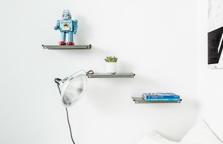 The cantilevered shelving in the bedroom was fashioned from vintage metal panels that were purchased online, Davison says. Photo by Alan Gastelum.