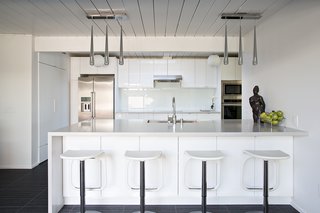 The kitchen remodel included creating more space and installing a single-plane island that served as the perfect spot for the family’s children to do everything from eating to studying schoolwork. Photo by Mariko Reed.