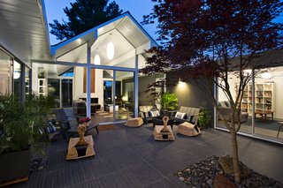 The living area opens beautifully into the outdoor area, which is a key design element of Eichler homes. Photo by Mariko Reed.