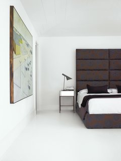 Barbara Hill on Designing Creative and Comfortable Rooms - Photo 4 of 6 - The home's bedroom features a large headboard designed by Hill. "I think a bedroom should be your go-to place for getting away from all the craziness," Hill says. "It should be very simple and warm." Photo by Gregory Miller.