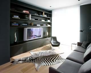 The media room is all about relaxing, whether in the nine-foot-long, extra-deep sofa from Minotti or the lounge chair from B&B Italia.Photo by <br><br>Ben Mayorga Photography