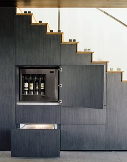 Modern Home Designed for Live Music in Beverly Hills - Photo 6 of 10 - The wall beneath the stairs holds hidden storage, including an Enomatic wine dispenser and Sub-Zero refrigerated drawers.
