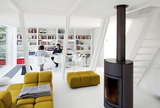In the living area, a Tufty-Time sofa by Patricia Urquiola for B&B Italia, a Soft Grid blanket by Established & Sons, and a wood-burning stove by Stûv keep her comfortable.