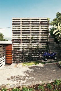 "Your first impression is that the house is very closed," says David Barragán of the building he designed with Jose María Sáez in Quito, Ecuador. Stacked concrete forms, developed by Barragán and Sáez and used as planters along the front facade, offer privacy and integrate the building with the site.