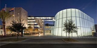 Chandler City Hall (Chandler, Arizona: 2010)<br><br>If only government was always this responsible. Built without accruing debt, the LEED Platinum-certified Chandler City hall, designed by SmithGroup, accomplishes a myriad of goals: bringing public space to Chicago Street in the city center, providing significant energy savings, and creating a public centerpiece for Chandler. The quartzite-clad structure also has fun being responsible: water from the HVAC system cascades in a waterfall down the north side of a parking tower, and the kinetic sculpture "Turbulent Shade," and interactive set of steel hinges and LED lights designed by artist Ned Kahn, glows at night thanks to power from the building’s solar panels. <br><br>Photo by SmithGroup JJR