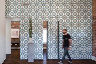 12 Creative Ways to Use Tile in Your Home - Photo 6 of 12 - Off the living room, two small bedrooms and a bathroom can be reached through sliding doors that, when closed, continue the cheerful pattern of the Moroccan cement tiles covering the wall.