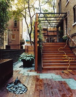 8 Small and Unexpected Garden Oases Hidden in the Middle of Cities - Photo 5 of 8 - A living wall, expertly located potted plants, and a mixture of paving materials bring a designer's eye to this formerly desolate, narrow rear yard in Manhattan's Upper West Side. The wooden planters and English ivy also provide privacy from the neighbors and help keep out noise without blocking light.