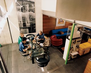 The double-height ceiling and ample northern light in the dining room make it rather cozy within.