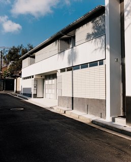Corrugated steel cladding defines the exterior.