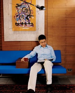 Langston-Jones created a custom armrest that he had made to fit snugly on his blue Slaapbank sofa designed by Martin Vissin.