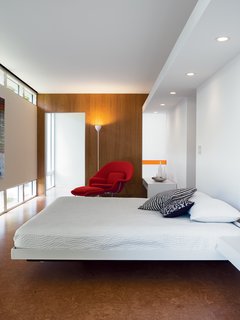 The bedroom is a comfortable show of geometric regularity.