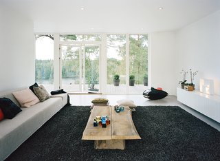Sum of Its Parts - Photo 4 of 12 - A long, low credenza in the living room keeps the space feeling open and airy.