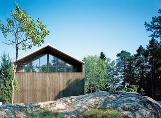 Sum of Its Parts - Photo 7 of 12 - The pitched facade has a sculptural play of spruce siding and triple-glazed windows that reflect the surrounding treetops.