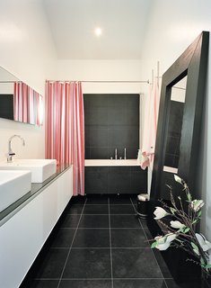 Sum of Its Parts - Photo 10 of 12 - The master bathroom is one of few spaces that lacks windows, but it opens onto the brilliantly daylit master bedroom.