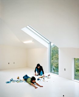 Magic Mountain - Photo 12 of 12 - To add extra illumination to the third floor loft, Wibowo placed Dan Flavinesque sculptural (and inexpensive) four-foot-long fluorescent tubes into the slanted ceiling.
