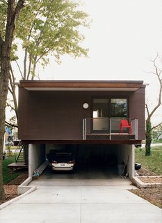 A rear view of the garage and the deck off the master bedroom.