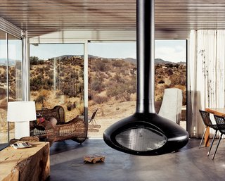 iT House, Joshua Tree - Photo 1 of 9 - A suspended fireplace by Fire Orb provides a shared hearth for friends and family to gather around.