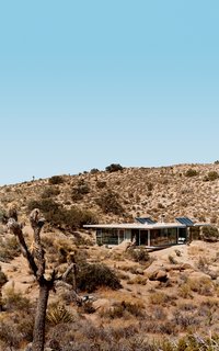 iT House, Joshua Tree - Photo 3 of 9 - Solar panels catch the sun's energy; wide expanses of open doors and windows provide cross-ventilation; and strategic overhangs shade against the desert's endless heat.