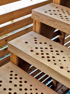 The stairs feature a geometric pattern of holes generated by a software script that allows rain to slip through to the lake below.