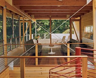 Lava Flow 4, The Big Island - Photo 3 of 9 - The living room, which opens directly to an ipe deck, is separated from the dining area by a central spiral staircase.