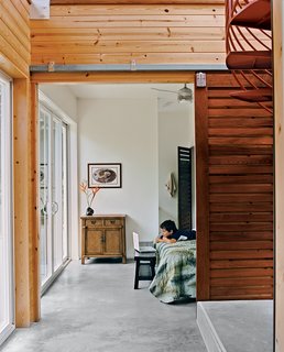 Lava Flow 4, The Big Island - Photo 9 of 9 - Kurokawa and Fishman's son Danny Fishman-Engel enjoys time away from the city by studying magic tricks in his bedroom. Sliding slatted doors separate the asymmetrical downstairs spaces.