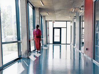 Resident Dorothy Barry, a former public school teacher, gazes out the ground-floor windows at a city where she was once temporarily without a home.