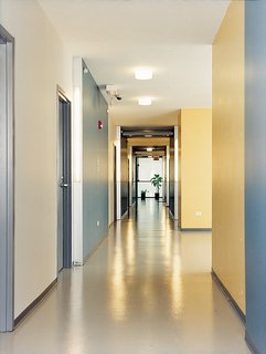 The spacious corridors of the Schiff Residences are clean, well-maintained, and warmly colored—-a convincing hybrid of social housing and home.