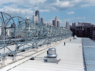 A horizon-line of rooftop wind turbines turns the skies of the Windy City into an omnipresent source of electrical power. Installed by the Chicago-based firm Aerotecture International, the turbines give the building both a steady supply of power and a distinct appearance, visible from several blocks away.