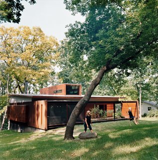 Opened House - Photo 1 of 7 - Maintaining a connection to their wooded backyard was an important consideration for the Edstorms. The back wall is designed to let in as much light and air as possible.