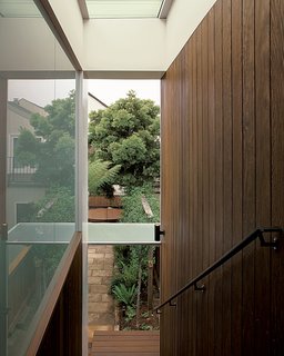A Garage Converted Modern Playroom - Photo 3 of 4 - The sheltered stairway, bordered on one side by glass and on the other by ipe planks, creates a gentle descent from the garage to the garden.