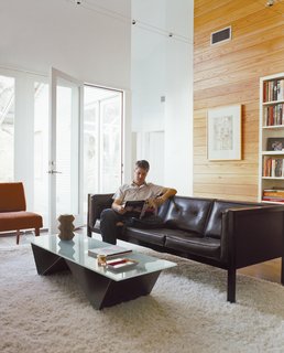 Double Time - Photo 3 of 7 - The living room isn’t large, but its high ceiling makes it feel airy, and furniture on slender legs allows light and air to circulate through the space.