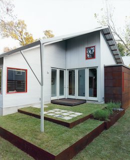 Double Time - Photo 7 of 7 - A back patio, designed by Allison’s sister, Jennifer Orr, a landscape architect, opens to the living room and to the office.