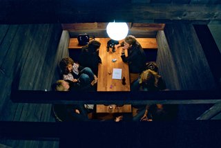 Inside the Boxhome, colors are muted, light remains local, and the dark-stained woods stand out against lighter grains. When residents and guests gather, the Boxhome's kitchen takes on a new role, bringing everyone to the table to talk.