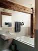 Modern home with Bath Room and Wall Mount Sink. Rather than concealing the barn frame in the private rooms, Cohen created an interplay between modern and historic elements in the master bathroom. Photo of Examples of Rustic Modern Done Right