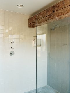 A massive pine beam defines the master bathroom.