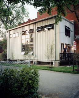 Jeff Walz gazes over the railing from the front stoop of his recycled steel–and–glass home, which replaced the quaint-but-decrepit 140-year-old farm-house in which he’d originally planned to reside
