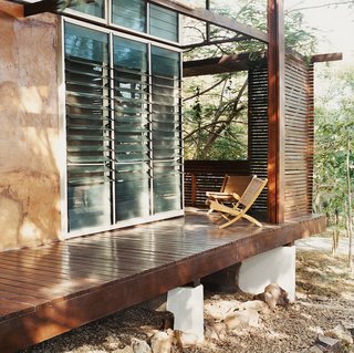 An Inno-native Approach - Photo 8 of 9 - Slatted wooden screens afford privacy and break the short but driving rains that blast the house from the southwest.