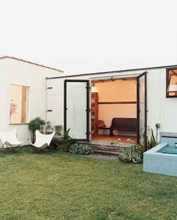 Expansive steel-and-glass doors open from the trailer to Siegal's back yard.