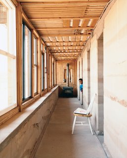 No Grid in Sight - Photo 7 of 8 - In wintertime, the rammed earth hallway wall serves as the central heating device, soaking up sunlight through south-facing windows and distributing warmth throughout the house. A wood-burning stove at the end of the front hallway provides additional heat for cold winter nights.