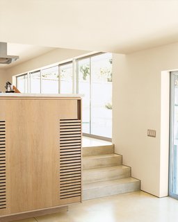 A half flight of stairs connects the main living area and the den.