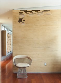 Stacked Baltic birch plywood strips encase the master bathroom, with gaps providing ventilation.