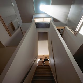 Architects Carrie and Kevin Burke designed their home to be a time-telling observatory. Sunlight is corseted through a 24-inch glass eye suspended just beneath a skylight, making the living room double as a sundial.