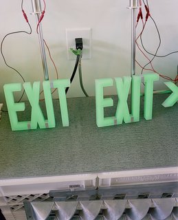 Custom exit sign are seen in the office.