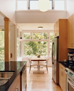 The kitchen leads into the dining area, which offers stunning views of the King’s River that flows past the house.