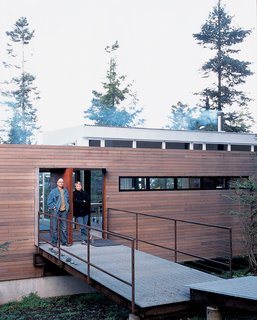 Galvanized steel is used to bridge the gap between natural landscape and structure in the entryway of the house.